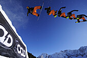 Snowboarder jumping from a kicker, performing a stunt, funpark Ehrwalder Alm, Tiroler Zugspitzarena, Ehrwald, Tyrol, Austria