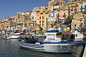 Fishing boats in harbor town in background Sciacca Sicily Italy Europe