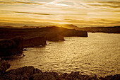 Cliffs and Virgen del Mar beach at sunset, Bay of Biscay, Santander, Cantabria, Spain