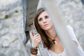 Under wooden fence young woman portrait