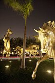 Golden Horses in front of Medinat Jumeirah hotel at night, Dubai, United Arabian Emirates