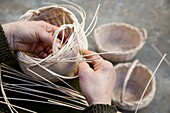 woman´s hands making wicker baskets in the Sierra de Aracena, Huelva,manos de mujer haciendo canastos de mimbre en la Sierra de Aracena, Huelva