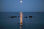 Photo Joergen Larsson Canoeing in moonlight Småland Sweden