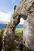 Climbers on a rocky window at Breitenstein moutain near Fischbachau, Wendelstein Mountain Range, Alps, Upper Bavaria, Germany