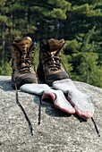 Hiking boots and socks on a large rock