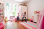 Two children playing in child's room, Hamburg, Germany