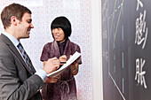 Chinese teacher and German businessman near blackboard, Confucius Institute Leipzig, Leipzig, Saxony, Germany