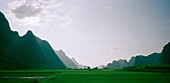 A valley in the Guangxi countryside with the Guilin mountains, China