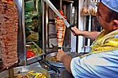 Grand Bazaar,A kebab restaurant man cutting meat, Istanbul, Turkey