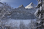 Winter landscape at Tschingelsee lake Tschingel in Kiental, Bernese Alps, with mornig fog  The valley Kiental is part of the UNESO heritage site Jungfrau-Aletsch-Bietschhorn    Kiental, Bernese Alps, Bern, Switzerland