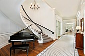 Foyer in traditional home with curved staircase