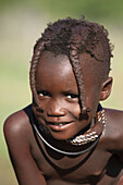 Himba girl smiling, Kaokoland, Namibia.