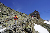 Woman ascending to mountain hut Schoene Aussicht, Schnals valley, Oetztal Alps, Vinschgau, Trentino-Alto Adige/Südtirol, Italy