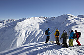 Group of skiers in front of mountain range, Pischa, Davos, Canton of Grisons, Switzerland