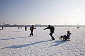 Persons on frozen outer Alster in winter, Hamburg, Germany