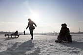 Persons on frozen outer Alster in winter, Hamburg, Germany