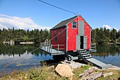 red fish shack on water near world heritage city of Lunenburg, Mahone Bay, Nova Scotia, Canada, North America.