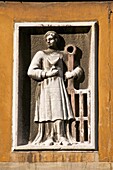 Saint Lorenzo and torture instrument, the grill, street carved plaque, Venice, Italy
