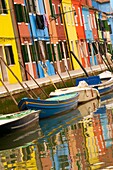 coloured houses and boats on canal, the island of Burano Venice Italy