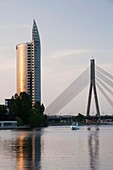 Latvia, Riga, Vansu Bridge, Swedbank building, and Daugava River, dusk