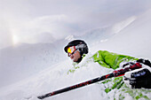 Male free skiers lying in deep snow, Mayrhofen, Ziller river valley, Tyrol, Austria