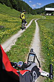 Mountainbiker with GPS device on handle bar, Reit im Winkl, Bavaria, Germany, Europe