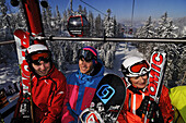 Skiers and snowboarder at cable car, Reit im Winkl, Chiemgau, Upper Bavaria, Bavaria, Germany, Europe