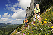 Couple with climbing equipment in the mountains, Gamssteig fixed rope route, Steinplatte, Reit im Winkl, Chiemgau, Upper Bavaria, Bavaria, Germany, Europe