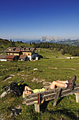 Hiker having rest at Eggenalm, Straubinger Haus, Reit im Winkl, Chiemgau, Upper Bavaria, Bavaria, Germany, Europe