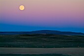 full moon over field in southern Alberta, Canada
