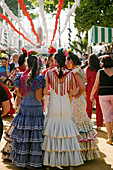 Women wearing a flamenco style dress in the Seville Spring Fair, Seville, Andalusia, Spain