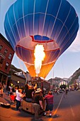 Hot air balloons illuminated at night by their propane burners, Telluride Balloon Festival, Main Street, Telluride, Colorado USA