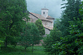 Monasterio de San Millan de Suso monastery amidst green trees, La Rioja, Northern Spain, Spain, Europe