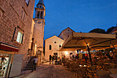 Restaurant in front of Sveti Ivana cathedral in the evening, Budva, Montenegro, Europe