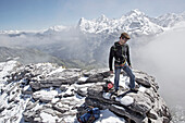 Man standing on a rock, Schilthorn, Bernese Oberland, Canton of Bern, Switzerland