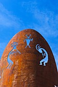Native Southwestern pictograph images decorate a steel monolith outside of the public library in Black Canyon, Arizonz A metal sculpture, built by late resident Will Smith The sculpture is of a story teller telling of native American lore