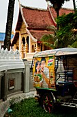 Tuk-tuk waiting at the door of Mixayaram buddhist temple, Vientiane, Laos