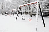 A village children’s playground under a blanket of snow Wrington, Somerset, England, United Kingdom