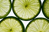slices of lime, lit from behind Isolated against white