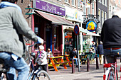 Street scene with cyclist in front of a coffee shop, Amsterdam, Netherlands