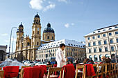 Odeonsplatz with pavement cafe and Theatine Church in winter, Munich, Bavaria, Germany