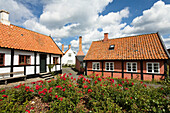 Frame houses under clouded sky, Gudhjem village, Bornholm, Denmark, Europe