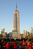 Roof-top terrace bar with view at the State Empire Building overtops all other high-rise buildings in Manhattan, New York, USA