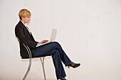 Adult, Attractive, Background, Beautiful, Business, Caucasian, Chair, Communication, Computer, Conduct, Confident, Dress, Face, Female, Girl, Hold, Isolated, Lady, Laptop, Modern, Office, People, Person, Portrait, Pretty, Professional, Single, Sit, Smile,