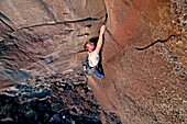 Greg Moore rock climbing Big Dude on The Tall Cliffs at Dierkes Lake Park near the city of Twin Falls in the Snake River Canyon of southern Idaho