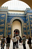 Visitors looking at Ishtar Gate from Babylon at Pergamon Museum in Berlin Germany