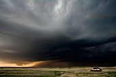 A storm chaser's car is parked as a storm chaser watched a lowering wall cloud a precursor to a tornado near Hill City, Kansas, USA, 4/24/2008