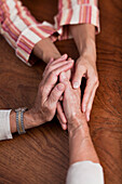 Senior and mature women holding hands