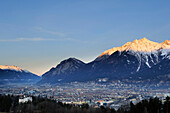 Innsbruck with alpenglow at Northern range of Karwendel in background, Innsbruck, Tyrol, Austria, Europe