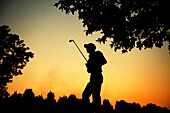 Spanish golfer Pablo Larrazabal is silhouetted against evening orange sky during the fourth day of the 50th UBS Hong Kong Open Golf Championship, China.